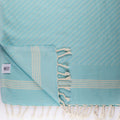 Colorful zig zag pattern lightweight Turkish Bath & Home towel draped over a surface, showcasing vibrant design and soft texture.