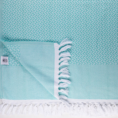 Turkish Bath & Home Crossword Flat Weave Towel featuring a woven pattern in neutral tones, displayed folded on a clean background.