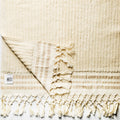 Small Turkish Hand & Thick Hand Towel from Turkish Bath & Home draped over a hook, showcasing soft, textured fabric.