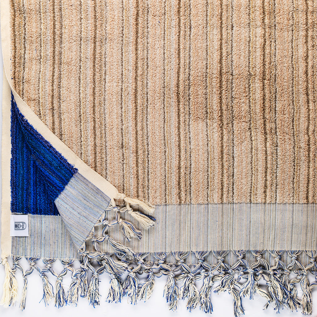 Large thick blue and ecru handwoven Turkish bath towel with intricate woven pattern, ideal for bathroom or beach use.