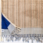 Large thick blue and ecru handwoven Turkish bath towel with intricate woven pattern, ideal for bathroom or beach use.