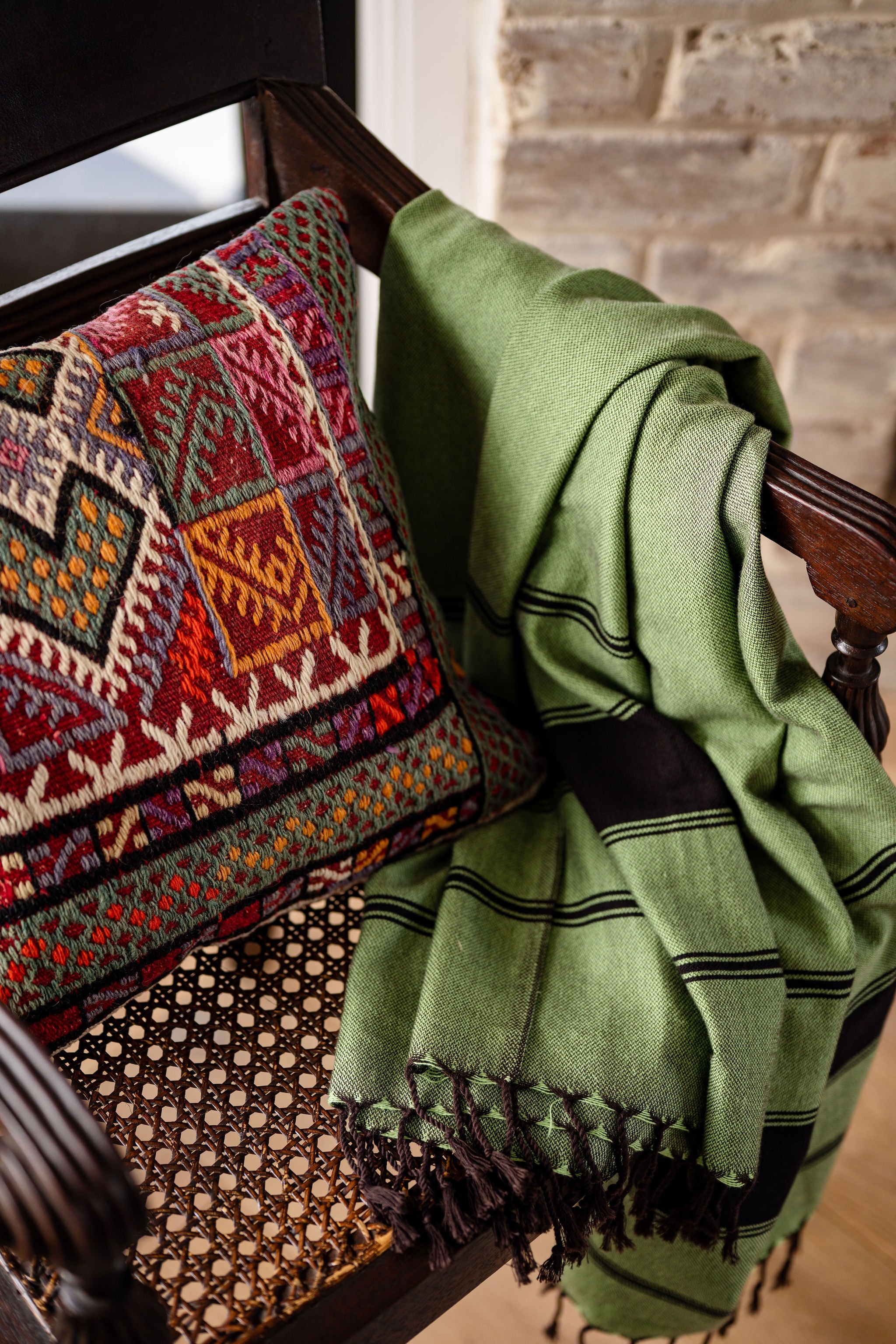 Turkish Bath & Home chocolate bold stripe flat weave towel with green and chocolate stripes, showcasing soft, textured fabric.