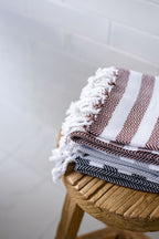 Lightweight Turkish Bath & Home hand towel with a stylish stripe cross design and flat weave texture.