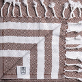 Turkish Bath & Home lightweight hand towel with a stripe cross design, soft and absorbent for everyday use.