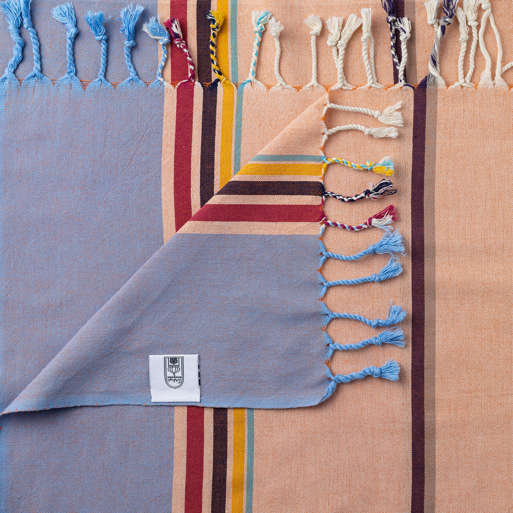 Turkish Bath & Home modern multi stripe lightweight towel in peach and mauve, featuring vibrant colors and soft, absorbent fabric.