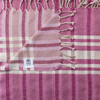 Pink Turkish Bath & Home stripe check lightweight towel displayed flat, showcasing its soft, breathable fabric and stylish pattern.