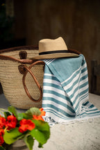 Turkish Bath & Home lightweight multi-stripe towel with summer flat weave, featuring vibrant multi-colored stripes for beach or spa use.