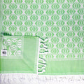Turkish Bath & Home octagonal leaf design flat weave towel with intricate leaf pattern and soft terry texture.