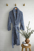 Thick blue and white looped terry towel robe from Turkish Bath & Home, with a cozy, plush texture and knee-length design.
